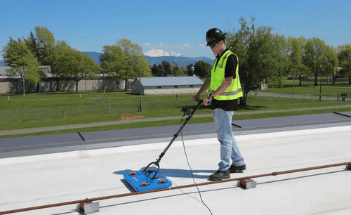 Electronic leak detection specialist scanning Dallas commercial flat roof membrane