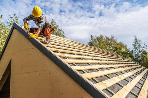 Roofing crew working on residential roof in Hurst TX