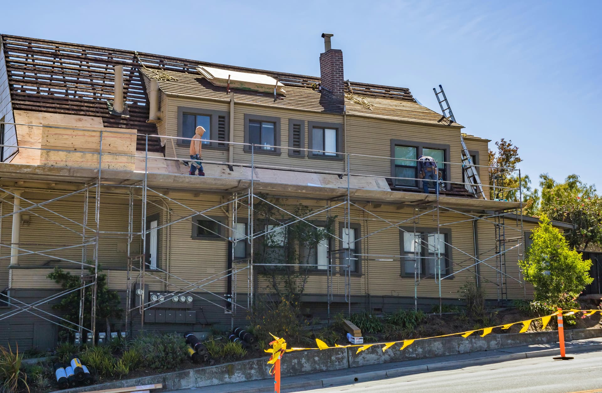 Residential home undergoing roof repair after hail damage in Arlington TX